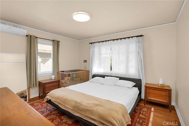 225 E 56th St, Long Beach, CA 90805 - bedroom with a wall mounted AC and light wood-style flooring