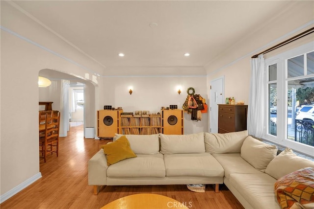 225 E 56th St, Long Beach, CA 90805 - living area featuring light wood-type flooring, healthy amount of natural light, arched walkways, recessed lighting, and ornamental molding