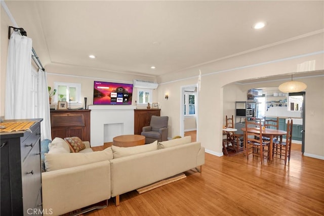 225 E 56th St, Long Beach, CA 90805 - living room featuring arched walkways, light wood-style flooring, and recessed lighting