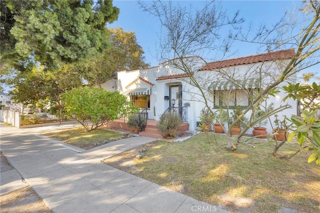 225 E 56th St, Long Beach, CA 90805 - mediterranean / spanish home featuring stucco siding and a tile roof