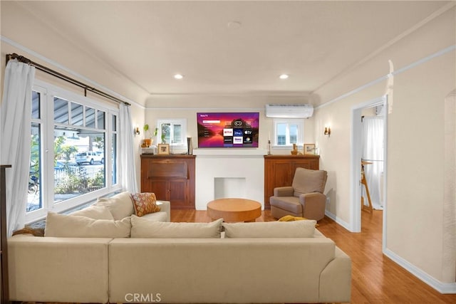 225 E 56th St, Long Beach, CA 90805 - living room with an AC wall unit, light wood-style flooring, ornamental molding, and recessed lighting