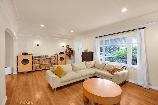 225 E 56th St, Long Beach, CA 90805 - living area featuring arched walkways, light wood-style flooring, crown molding, and recessed lighting