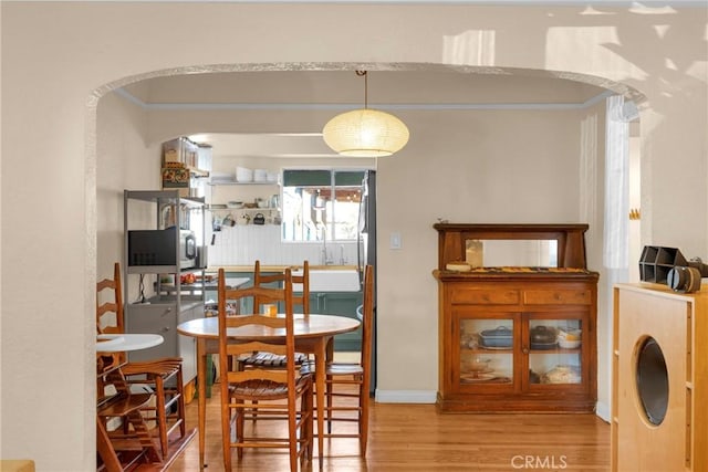 225 E 56th St, Long Beach, CA 90805 - dining area with wood finished floors and arched walkways