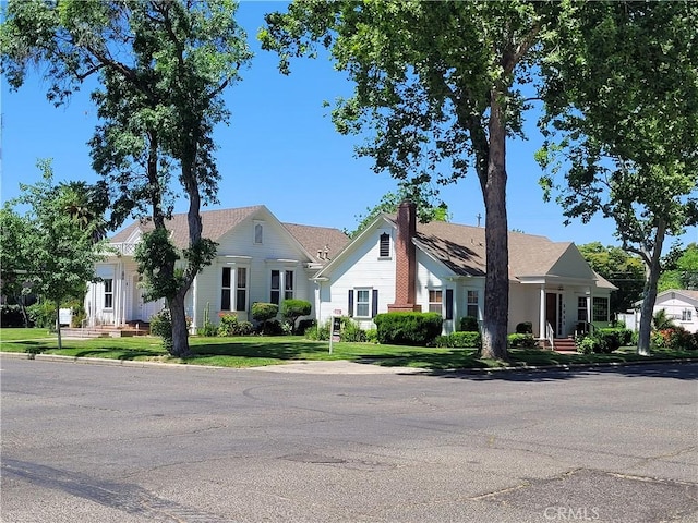 1948 K St, Merced, CA 95340 - view of front of house featuring a front lawn and a chimney