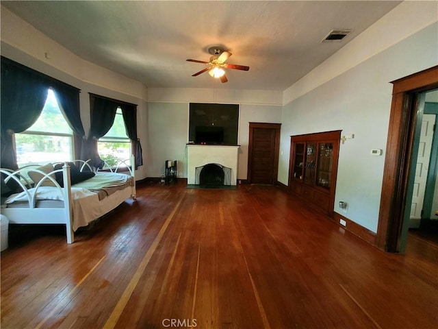 1948 K St, Merced, CA 95340 - living room featuring a ceiling fan, hardwood / wood-style floors, a fireplace with flush hearth, and baseboards