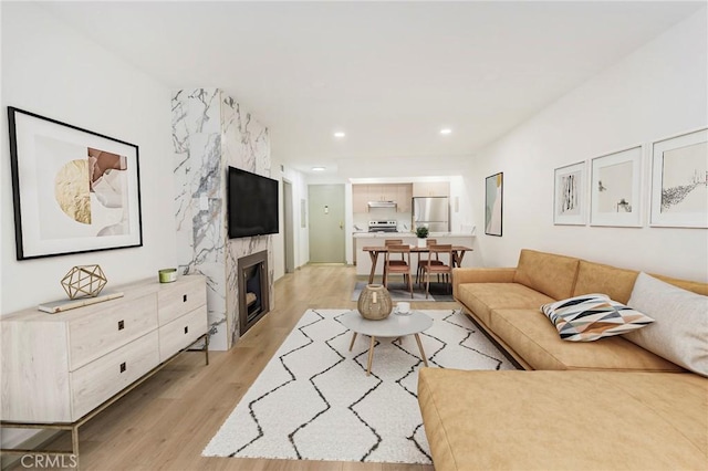1745 Camino Palmero St Unit 107, Los Angeles, CA 90046 - living room with light wood-style flooring, a fireplace, and recessed lighting