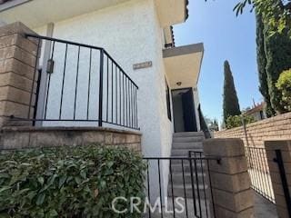 2208 N N Broadway Unit 33, Santa Ana, CA 92706 - view of home's exterior with stucco siding, a gate, and entry steps