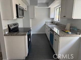 2208 N N Broadway Unit 33, Santa Ana, CA 92706 - kitchen with stainless steel microwave, range with electric stovetop, baseboards, a sink, and dishwasher