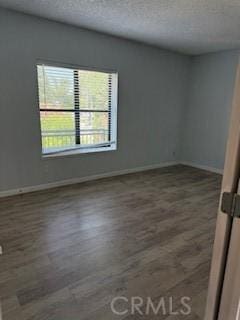 2208 N N Broadway Unit 33, Santa Ana, CA 92706 - spare room featuring wood finished floors, a textured ceiling, and baseboards