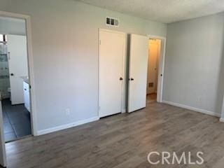 2208 N N Broadway Unit 33, Santa Ana, CA 92706 - unfurnished bedroom featuring baseboards and wood finished floors