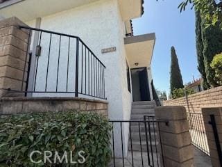 2208 N N Broadway Unit 33, Santa Ana, CA 92706 - view of side of property featuring stucco siding, a gate, and entry steps