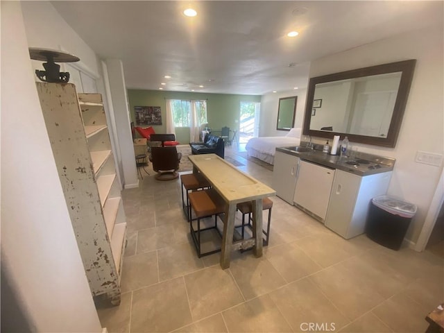 35450 Calle Nopal, Temecula, CA 92592 - kitchen with white dishwasher, white cabinetry, recessed lighting, light tile patterned flooring, and open floor plan