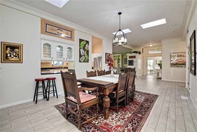 35450 Calle Nopal, Temecula, CA 92592 - dining room with a skylight, crown molding, and light wood finished floors