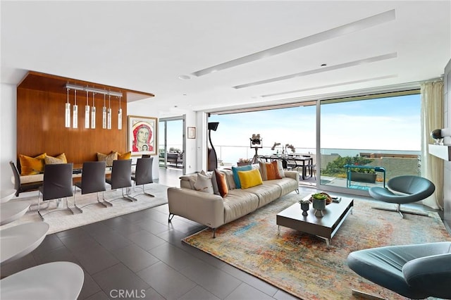 1088 Del Mar Ave, Laguna Beach, CA 92651 - living room featuring expansive windows, wooden walls, and tile patterned floors
