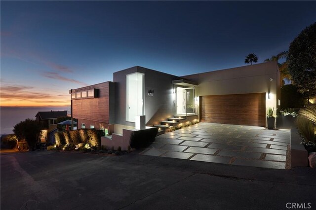 1088 Del Mar Ave, Laguna Beach, CA 92651 - contemporary home featuring a garage, driveway, and stucco siding