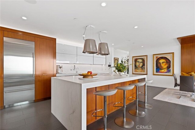 1088 Del Mar Ave, Laguna Beach, CA 92651 - kitchen with built in refrigerator, modern cabinets, light countertops, a kitchen island, and recessed lighting