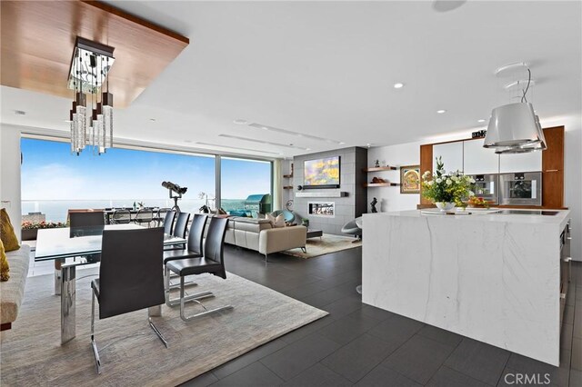 1088 Del Mar Ave, Laguna Beach, CA 92651 - dining space with recessed lighting, a wall of windows, a chandelier, and dark tile patterned floors