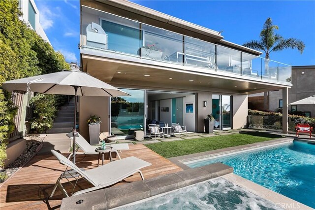 1088 Del Mar Ave, Laguna Beach, CA 92651 - rear view of house with a balcony, a hot tub, a patio, an outdoor pool, and stucco siding