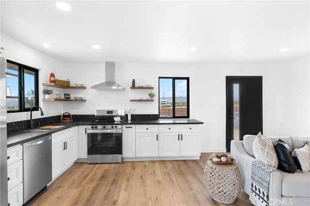 1561 Shoshone Valley Rd Unit 29, Palms, CA 92277 - kitchen featuring open shelves, appliances with stainless steel finishes, wall chimney exhaust hood, a sink, and recessed lighting