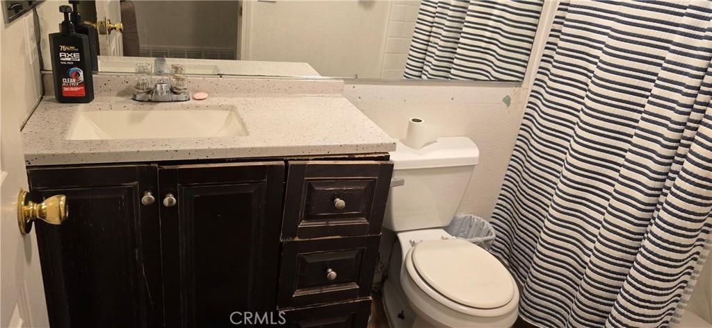 25651 Dracaea Ave, Moreno Valley, CA 92553 - full bath with vanity, toilet, and a shower with shower curtain
