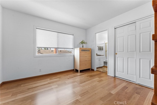 6421 Acacia Hill Dr, Yorba Linda, CA 92886 - bedroom featuring light wood finished floors, baseboards, connected bathroom, and a closet