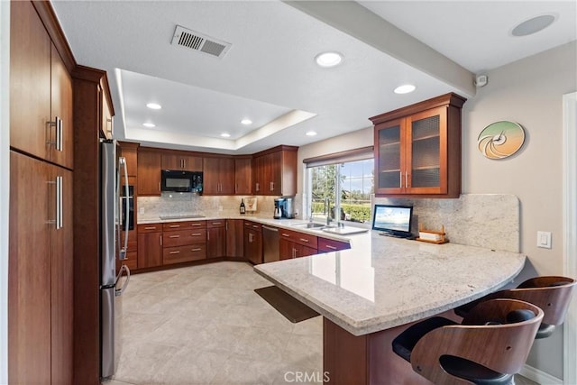 6421 Acacia Hill Dr, Yorba Linda, CA 92886 - kitchen with appliances with stainless steel finishes, a peninsula, tasteful backsplash, glass insert cabinets, and recessed lighting