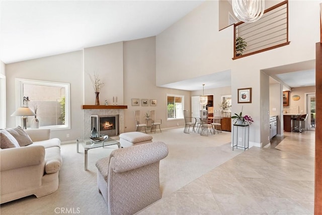6421 Acacia Hill Dr, Yorba Linda, CA 92886 - living area with high vaulted ceiling, baseboards, carpet flooring, and a warm lit fireplace