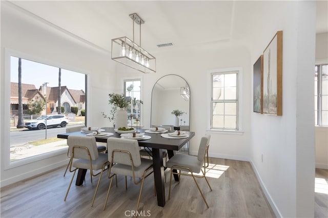 1116 W 80th St, Los Angeles, CA 90044 - dining room with wood finished floors, healthy amount of natural light, and baseboards