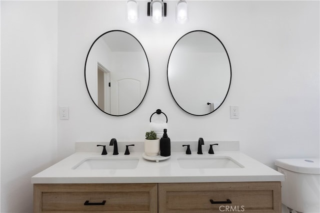 1116 W 80th St, Los Angeles, CA 90044 - bathroom featuring double vanity and toilet