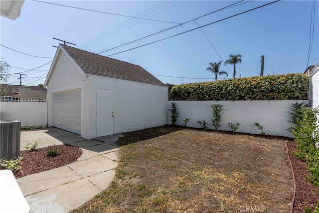 1116 W 80th St, Los Angeles, CA 90044 - view of yard with cooling unit, a detached garage, an outbuilding, and concrete driveway