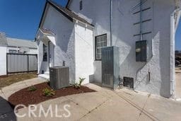 1116 W 80th St, Los Angeles, CA 90044 - view of side of property featuring stucco siding and cooling unit