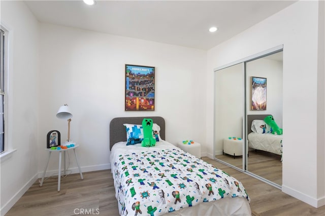 1116 W 80th St, Los Angeles, CA 90044 - bedroom with wood finished floors, a closet, baseboards, and recessed lighting
