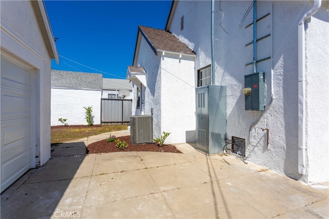 1116 W 80th St, Los Angeles, CA 90044 - view of side of property with stucco siding, central air condition unit, and a patio area