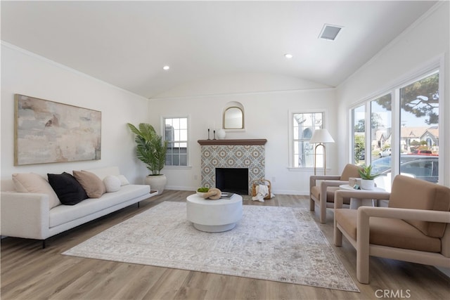 1116 W 80th St, Los Angeles, CA 90044 - living area with vaulted ceiling, baseboards, a tile fireplace, wood finished floors, and recessed lighting