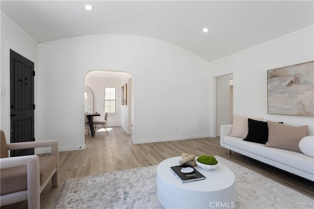 1116 W 80th St, Los Angeles, CA 90044 - living room featuring arched walkways, lofted ceiling, light wood finished floors, baseboards, and recessed lighting