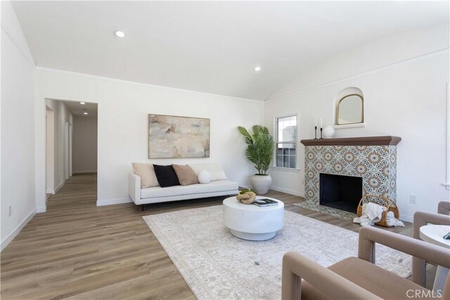 1116 W 80th St, Los Angeles, CA 90044 - living area featuring light wood-style flooring, lofted ceiling, baseboards, recessed lighting, and a fireplace