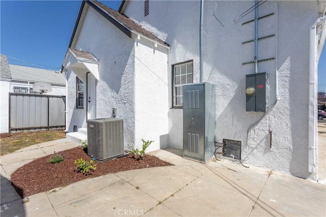 1116 W 80th St, Los Angeles, CA 90044 - view of property exterior featuring stucco siding, central air condition unit, and a patio