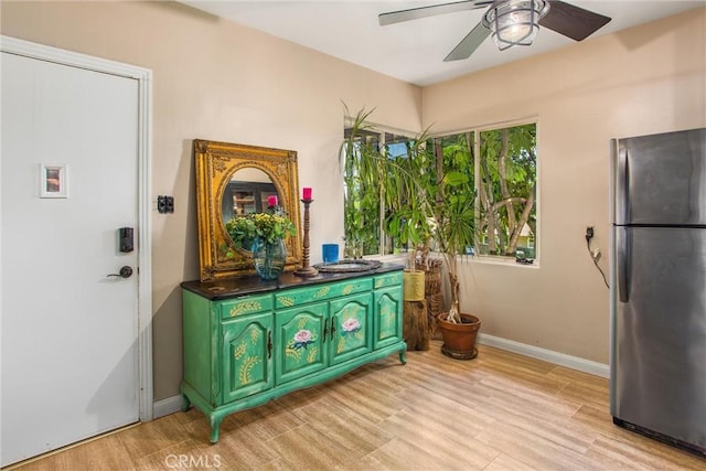 1872 Arroyo Dr, Riverside, CA 92506 - kitchen featuring freestanding refrigerator, ceiling fan, dark countertops, green cabinetry, and light wood-style floors