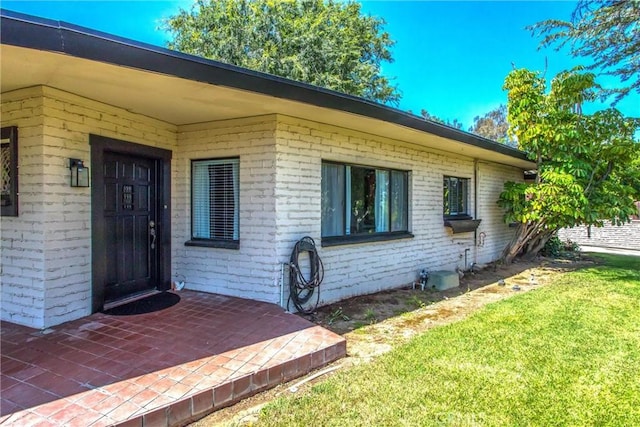1872 Arroyo Dr, Riverside, CA 92506 - property entrance with a yard and brick siding