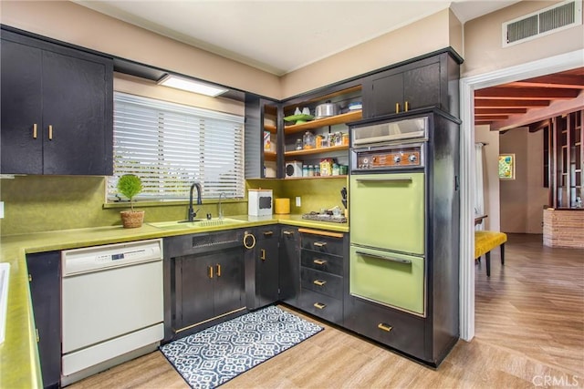 1872 Arroyo Dr, Riverside, CA 92506 - kitchen with dishwasher, a sink, light wood-style flooring, and light countertops