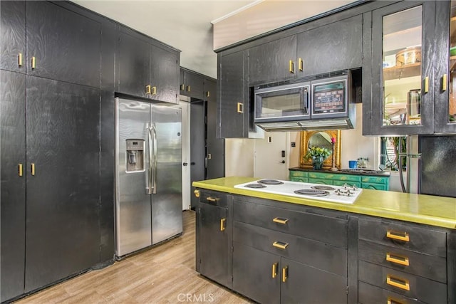 1872 Arroyo Dr, Riverside, CA 92506 - kitchen with stainless steel appliances, light wood-style flooring, glass insert cabinets, and dark cabinets