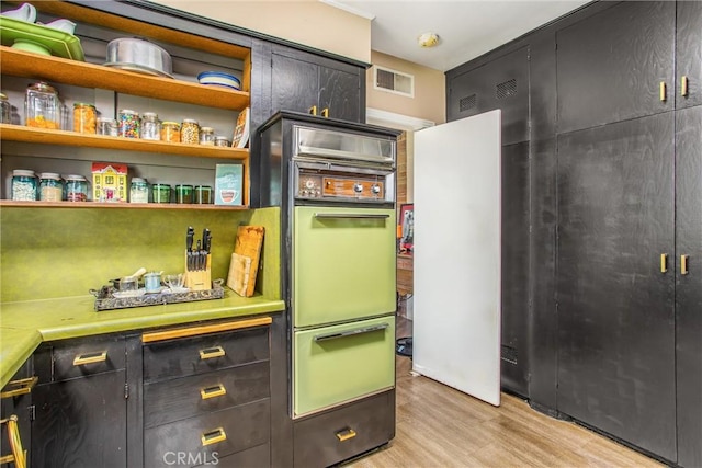 1872 Arroyo Dr, Riverside, CA 92506 - kitchen featuring light wood-style flooring, light countertops, open shelves, and dark cabinets