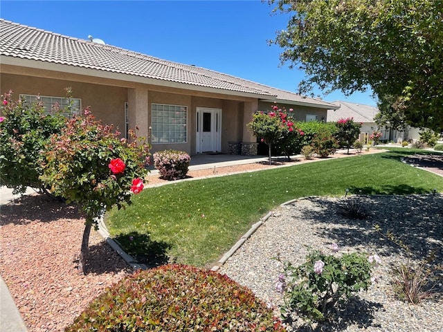 6940 Oak Vista Ln, Oak Hills, CA 92344 - rear view of property with stucco siding, a yard, and a tiled roof