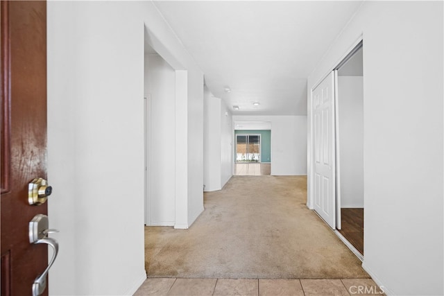 11877 Crossbill Way, Jurupa Valley, CA 91752 - corridor with light carpet, light tile patterned floors, and baseboards