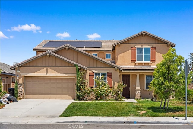 11877 Crossbill Way, Jurupa Valley, CA 91752 - craftsman-style home with driveway, a front yard, a garage, a tiled roof, and stucco siding