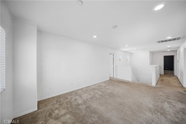 11877 Crossbill Way, Jurupa Valley, CA 91752 - empty room featuring light colored carpet, recessed lighting, and baseboards