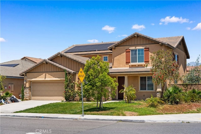 11877 Crossbill Way, Jurupa Valley, CA 91752 - craftsman-style house featuring an attached garage, stucco siding, concrete driveway, a front lawn, and roof mounted solar panels