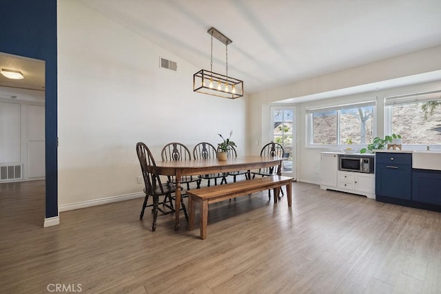 27721 Wakefield Rd, Castaic, CA 91384 - dining space featuring light wood-style floors, vaulted ceiling, and baseboards