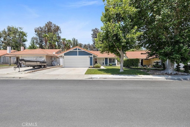 27721 Wakefield Rd, Castaic, CA 91384 - view of front of house featuring an attached garage, concrete driveway, a chimney, and a front lawn