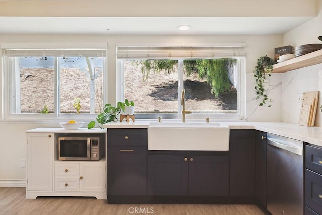 27721 Wakefield Rd, Castaic, CA 91384 - kitchen featuring stainless steel appliances, a sink, light wood-style flooring, light countertops, and open shelves